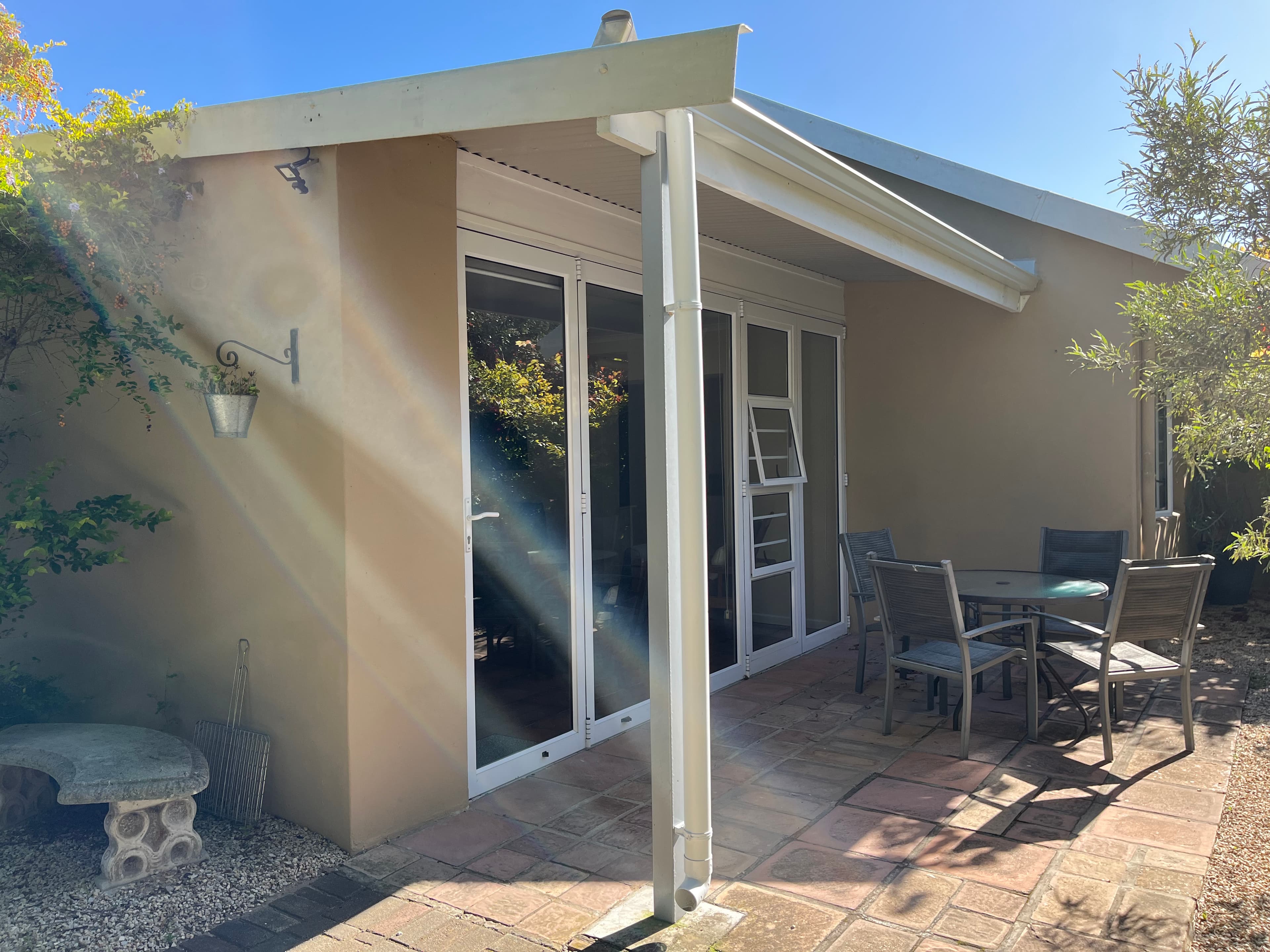 Covered patio with outdoor seating at Little Louisa